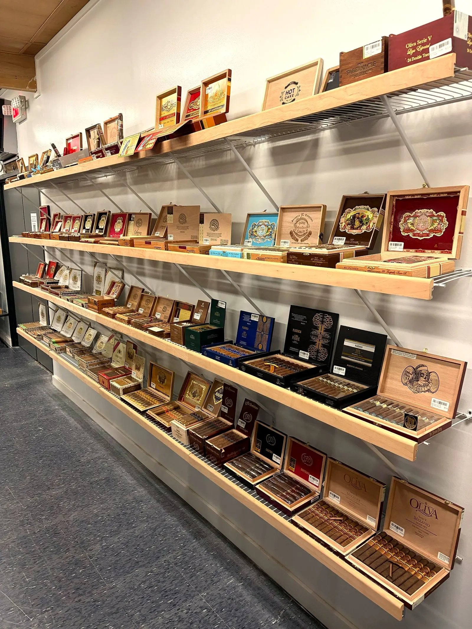 Premium cigar boxes lining the singles wall
